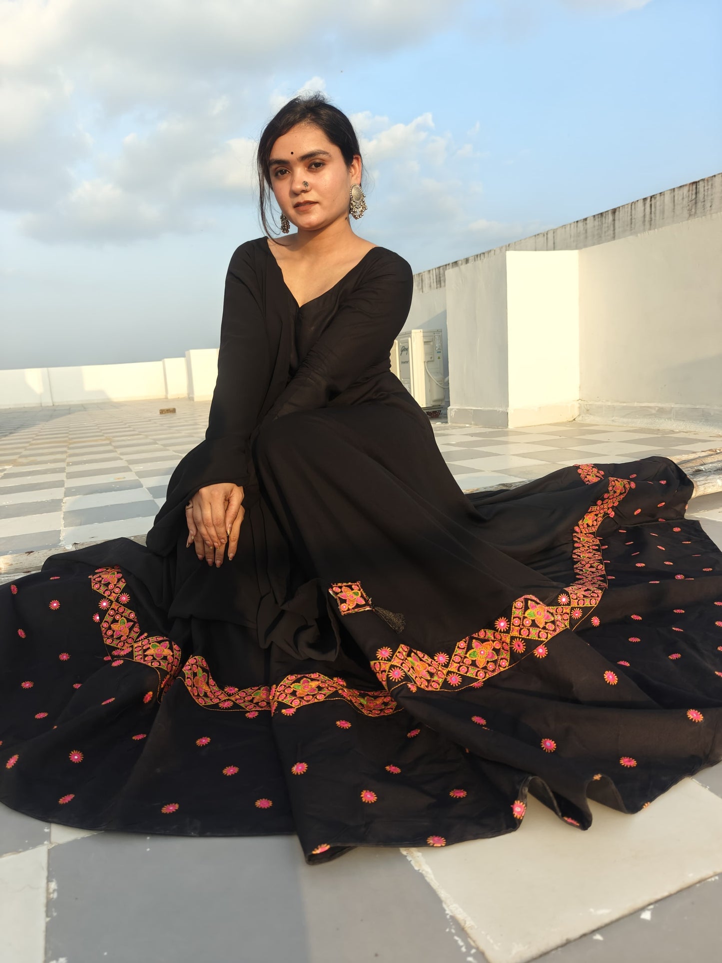 Detailed embroidery and tassel work on the dupatta and hem of black rayon Anarkali dress
