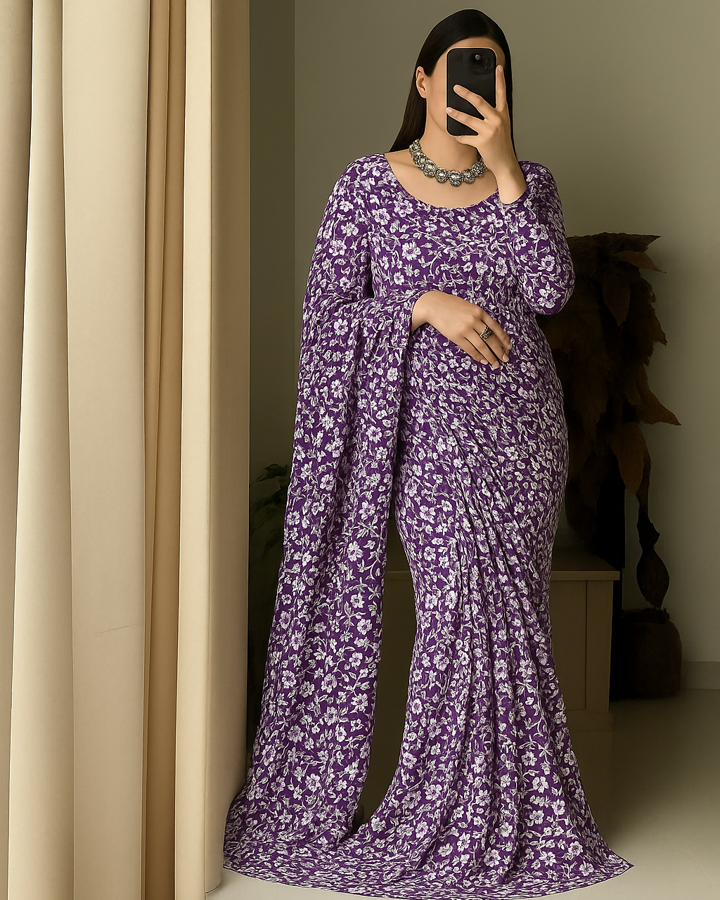 A woman wearing a purple floral Ready to wear saree standing in front of a mirror.