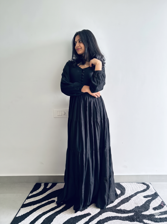 Woman wearing black rayon tiered maxi dress with covered-button front, sweetheart neckline and balloon sleeves, full-length view – Vastramaniaa