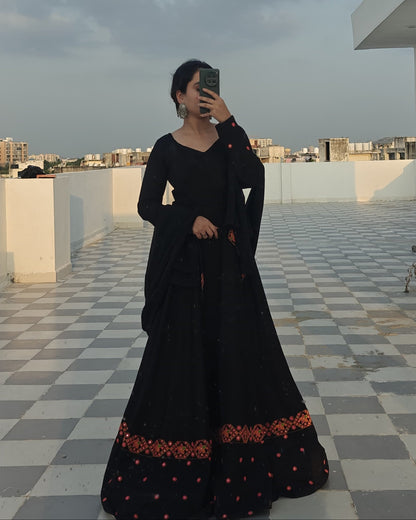 Woman wearing black embroidered full-flared rayon Anarkali dress with dupatta, V-neck and long sleeves – festive ethnic outfit