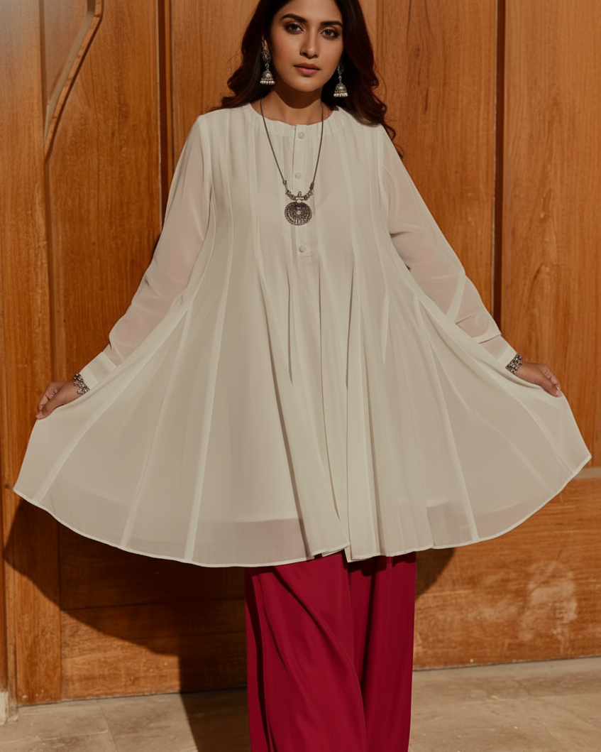 Woman wearing a beige top and red pants against a wooden background