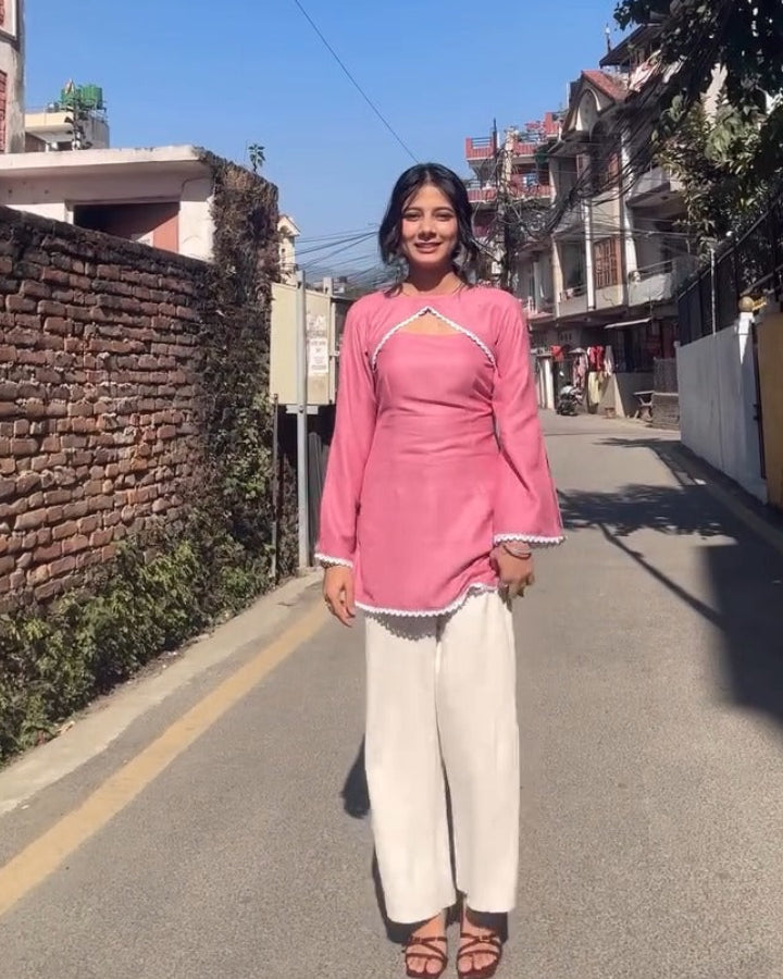 Woman in a pink kurthi standing on a street with text overlay